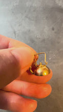 Load and play video in Gallery viewer, gold teapot charm turned in hand on grey background
