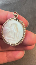Load and play video in Gallery viewer, French Mother of Pearl Rafael’s Cherub 18K White Gold Seed Pearl Medal Pendant
