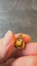 Load and play video in Gallery viewer, gold basket with white pearl turned in hand on grey background
